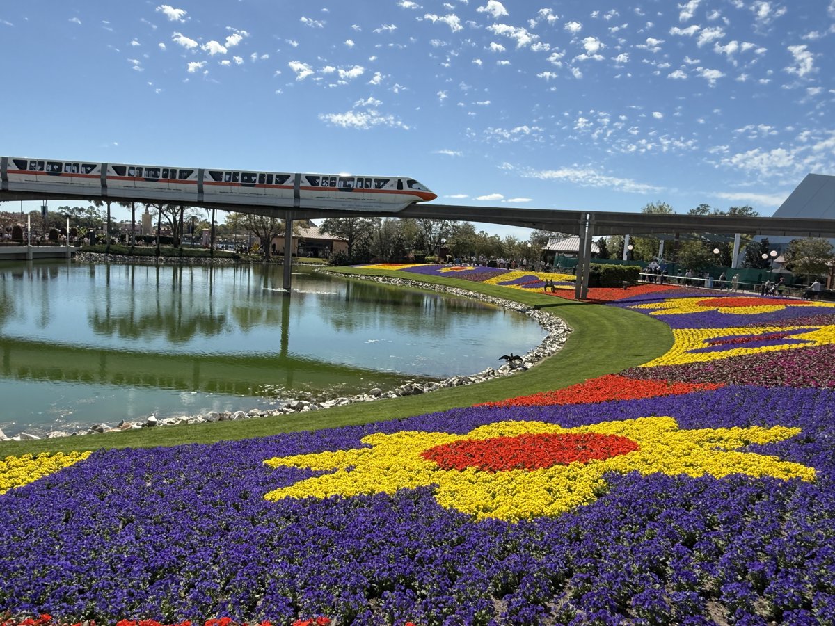 EPCOT Flower & Garden Festival — monorail over colorful flower beds and lagoon