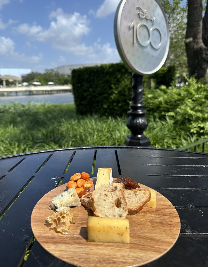 Cheese board with honeycomb, nuts, and bread on a festival table