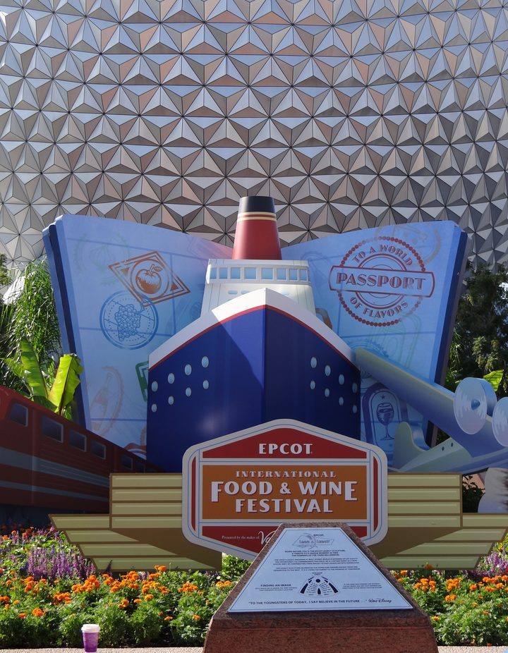 Food & Wine Festival entrance display with ship, passport, and Spaceship Earth