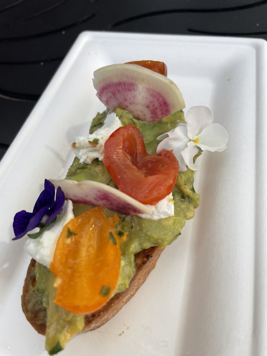 Avocado toast with edible flowers from an outdoor kitchen