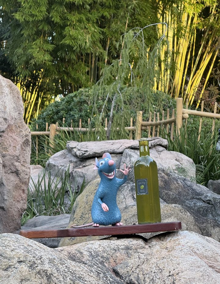 Chef Remy statue with an olive oil bottle hidden among the rocks